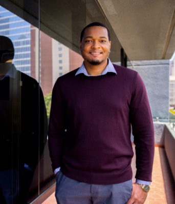 JKF law student standing new to the law building